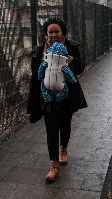 Ann carrying her son along the streets of Germany.