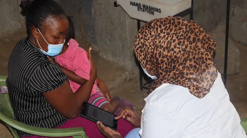 Maximilla being attended to by Waida Kasaya, clinical officer at the Beyond Zero clinic in Karanja, Kibera.
